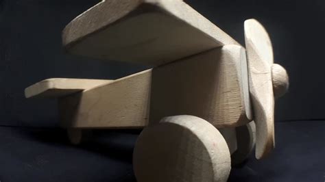 Premium stock video - Wooden toy airplane in the dark. close up