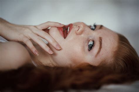 Blue Eyes Model Open Mouth Lying On Back Finger On Lips Redhead