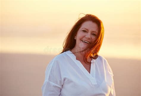Happy Days Its Vacation Time Mature Woman Standing On The Beach At Sunset Stock Photo Image