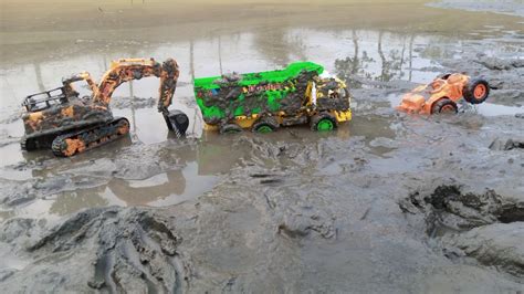 Truck Heavy Loaded Soil Aggregates Dumper Stuck In Deep Mud Pulling Out