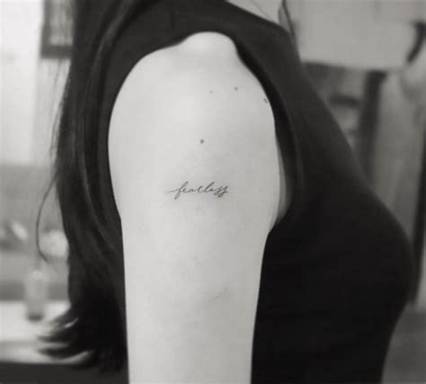 "Fearless" tattoo on upper arm