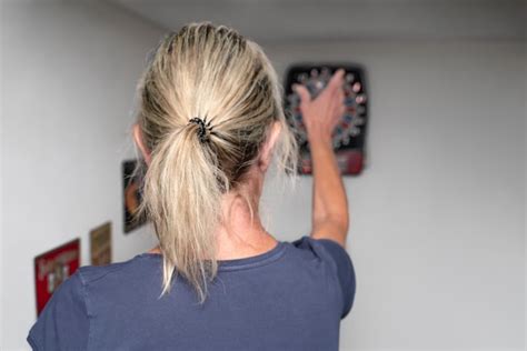 Premium Photo A Year Old Blonde Woman Plays Darts An Electric Dart