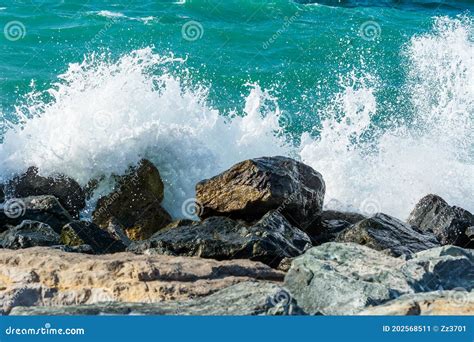 Waves Of Persian Gulf Splashing The Stones Of Breakwater At The