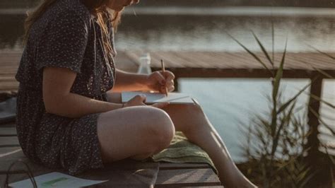 Premium Photo Midsection Of Woman Writing In Book While Sitting On