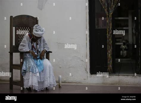 A Woman In Typical Dress Is Seen Sitting During The Afro Brazilian