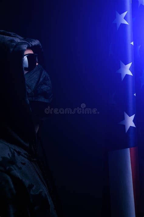 Hooded Man Wearing Black Glasses And Mask Looks Flag Of The United