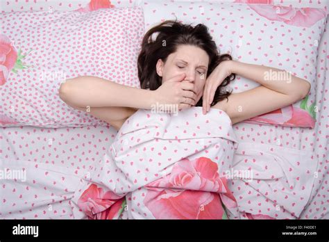 The Girl Woke Up Yawning In Bed Stock Photo Alamy