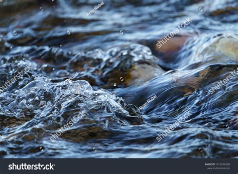 Closeup Gurgling Water Over Cobblestone River Stock Photo