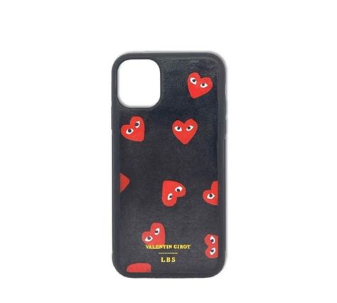 A Black Phone Case With Red Hearts And Eyes On The Front Against A