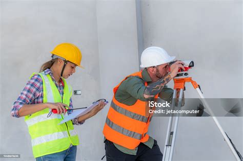 Construction Worker Using Theodolite Surveying Optical Instrument For