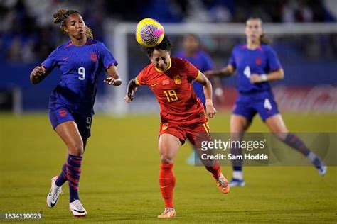 Zhang Minyan Of China Heads The Ball In Front Of Midge Purce Of News