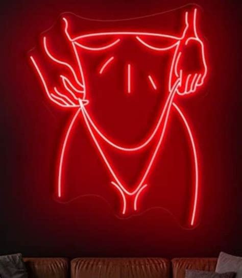 A Red Neon Sign With A Woman S Face In The Center And Hands On Her Hips