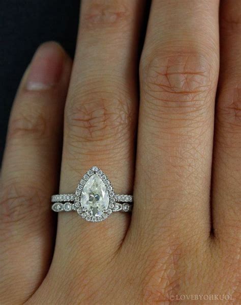 This Amazing Forever One Pear Shaped Moissanite Diamond Halo Engagement