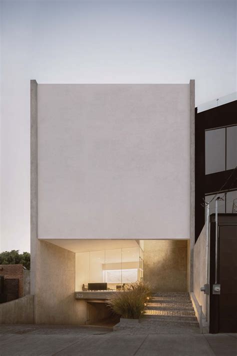 A White Building With Stairs Leading Up To The Top And Bottom Floor In