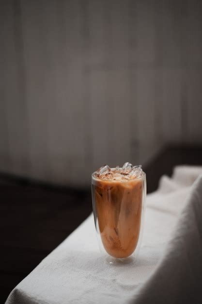 Premium Photo Glass Of Iced Coffee With Milk On The Table