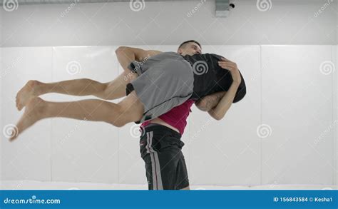 Greco-Roman Wrestlers in a White Room with Mats. Practicing Self ...