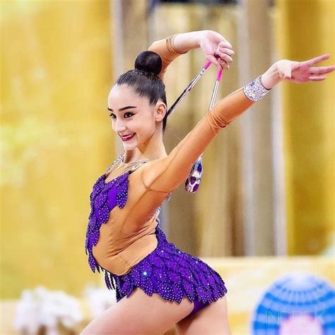 A Woman In A Purple Leotard Is Dancing