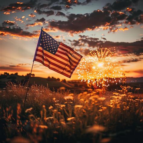 Premium Photo American Flag And Fireworks At Sunset Rural Field