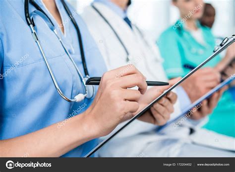 Nurse Writing In Clipboard Stock Photo By Dmitrypoch