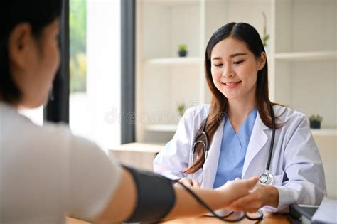 A Professional Asian Female Doctor Checking Patient S Pulse Heart Rate