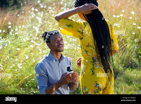 African Man Proposing To African Woman In Field Stock Photo Alamy