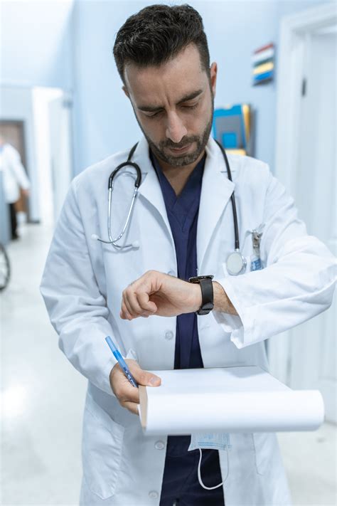 Physician in White Coat Wearing a Stethoscope · Free Stock Photo