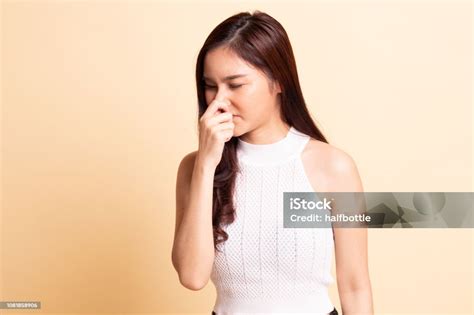 Young Asian Woman Holding Her Nose Because Of A Bad Smell Stock Photo