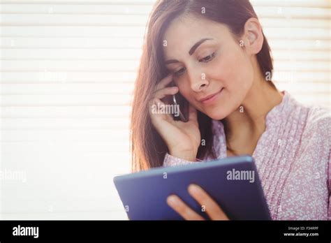 Pretty Brunette Using Her Tablet Stock Photo Alamy