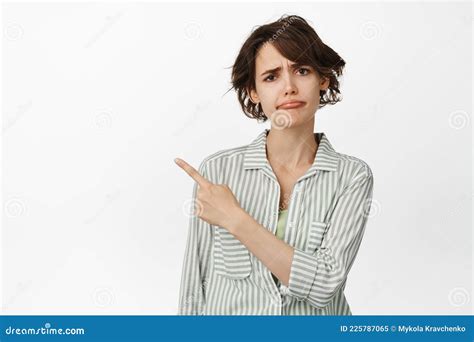 Disappointed Frowning Redhead Woman Pointing Finger Right At Something Bad Scolding Or