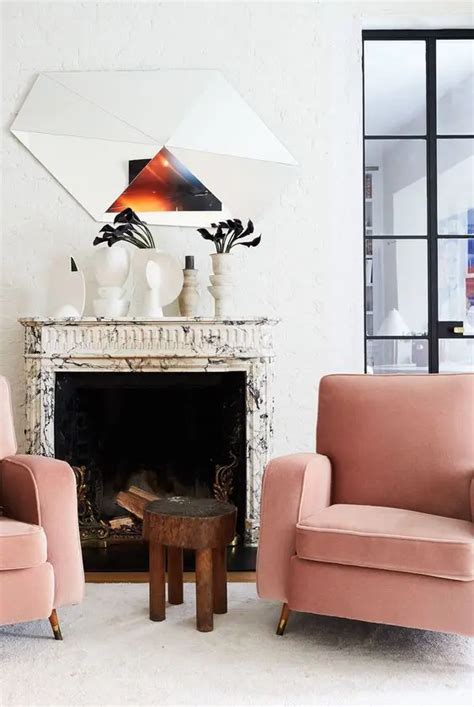 A Bold And Edgy Space With A Marble Clad Fireplace Pink Chairs A Side