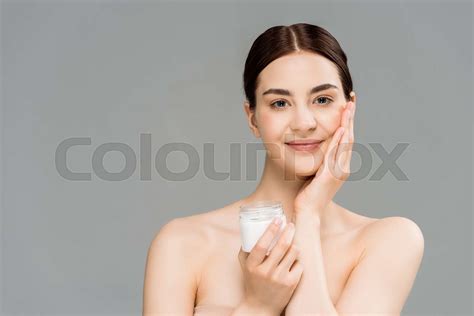 Happy Naked Woman Holding Container With Cosmetic Cream And Touching