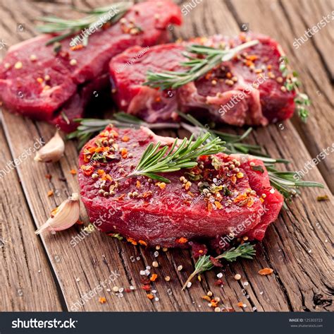 Raw Beef Steak On A Dark Wooden Table Stock Photo Shutterstock