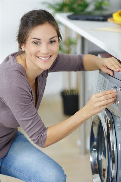 Young Woman Putting Laundry Into Washing Machine Stock Photo Image Of