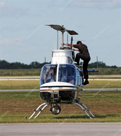 Pilot preparing police helicopter for flight — Stock Photo ...