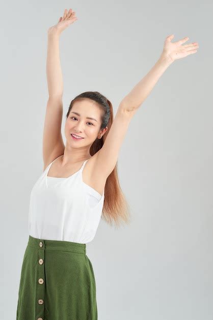 Premium Photo Happy Young Asian Woman Hands Up In The Air Over White