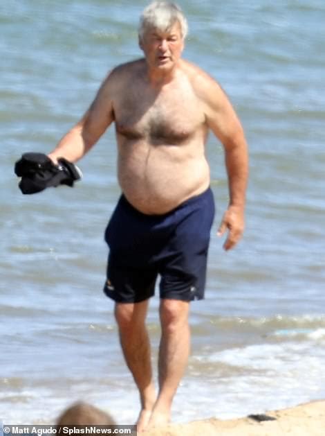 Alec Baldwin 64 Shows Off Shirtless Physique As He Frolics Across The