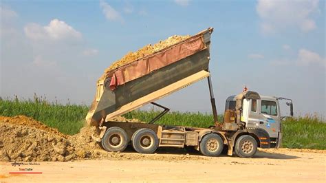 Operating Job Construction Dump Truck Dumping Dirt With Bulldozer