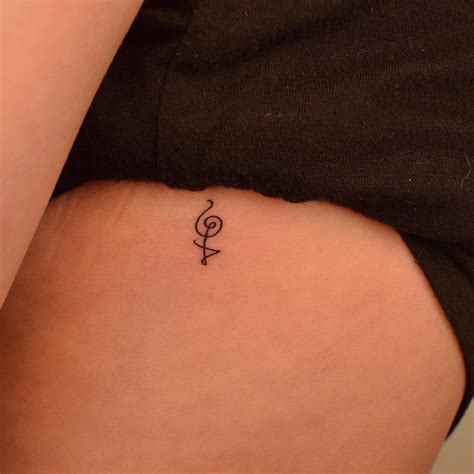 Hakuna Matata Symbol Tattooed On The Rib Minimalistic