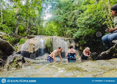 Deep Forest Waterfall With Tourist In Erawan National Park Kanchanaburi