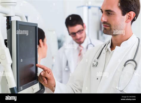 Doctor Diagnosing At Screen After MRI Scan In Hospital Stock Photo Alamy