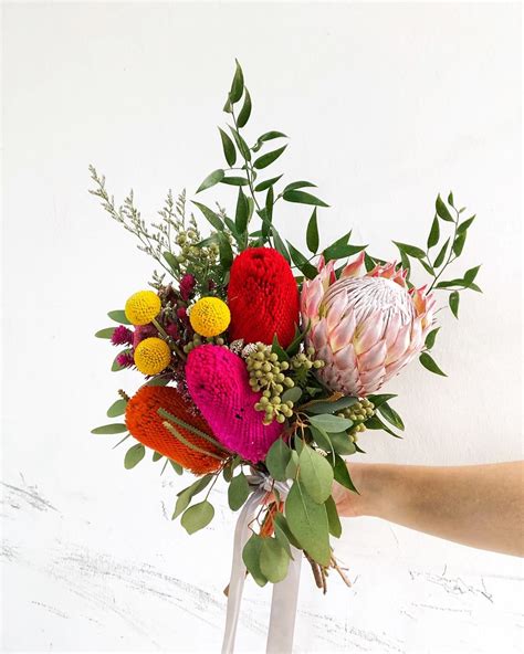 A colouful mix of blooms with the majestic king protea for this bridal ...