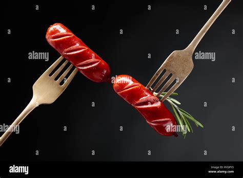 Grilled Sausages With Rosemary On A Forks Black Background Copy Space