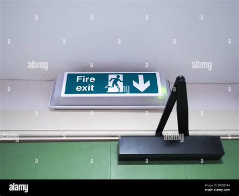 Fire Exit Sign Above Green Wooden Door Stock Photo - Alamy