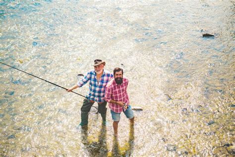 Premium Photo Fisherman Men Friends And Trophy Trout Father And Son