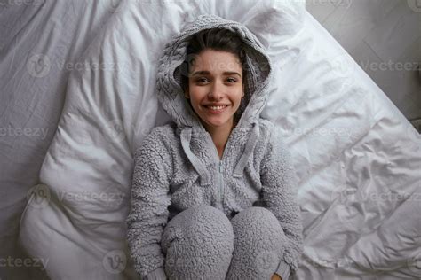 Indoor Shot Of Happy Attractive Young Brunette Female Dressed In Cosy