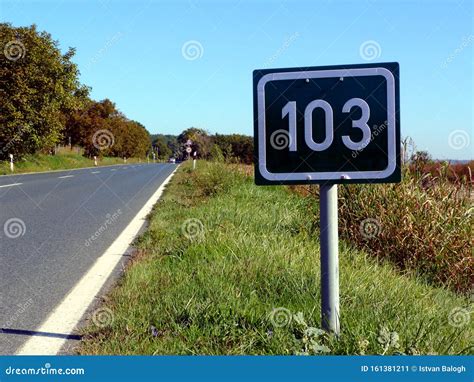 Green Metal Plate Mileage Sign With White Lettering On Road Side Stock