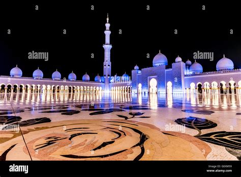 Zheikh Zayed Grand Mosque in Abu Dhabi at night bathed in a blue light ...