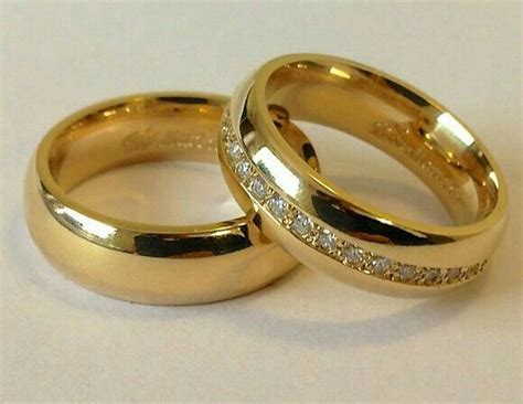 Two Gold Wedding Rings With Diamonds On Them