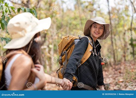 Cheerful Romantic Lesbian Couple Traveler With Backpack On Their Backs Go Hiking Through The