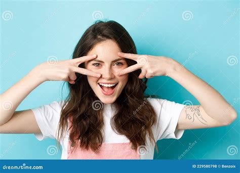 Close Up Of Attractive Excited Woman Showing V Signs Disco Gesture